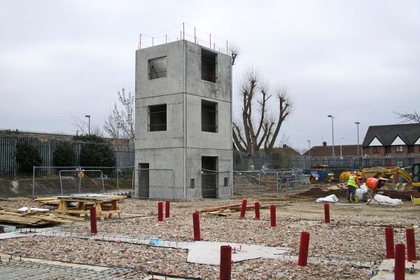 in progress installation of three-high precast concrete stair cores