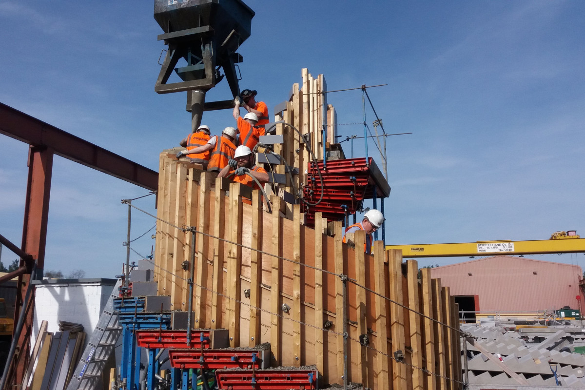 concrete pouring onto mould of helical precast concrete staircase