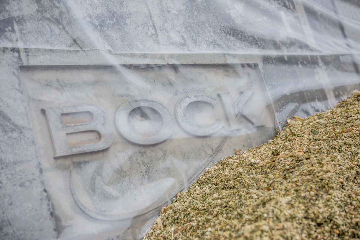 Close up of silage against precast concrete silage clamps branded 'Bock' at Harper Adams University