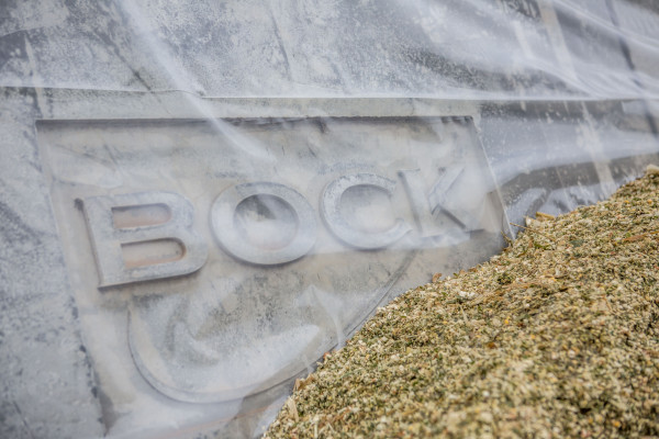 Close up of silage against precast concrete silage clamps branded 'Bock' at Harper Adams University