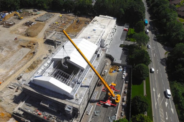 aerial view of mobile crane lift installation of precast concrete curved helical staircase in Denham, Bucks