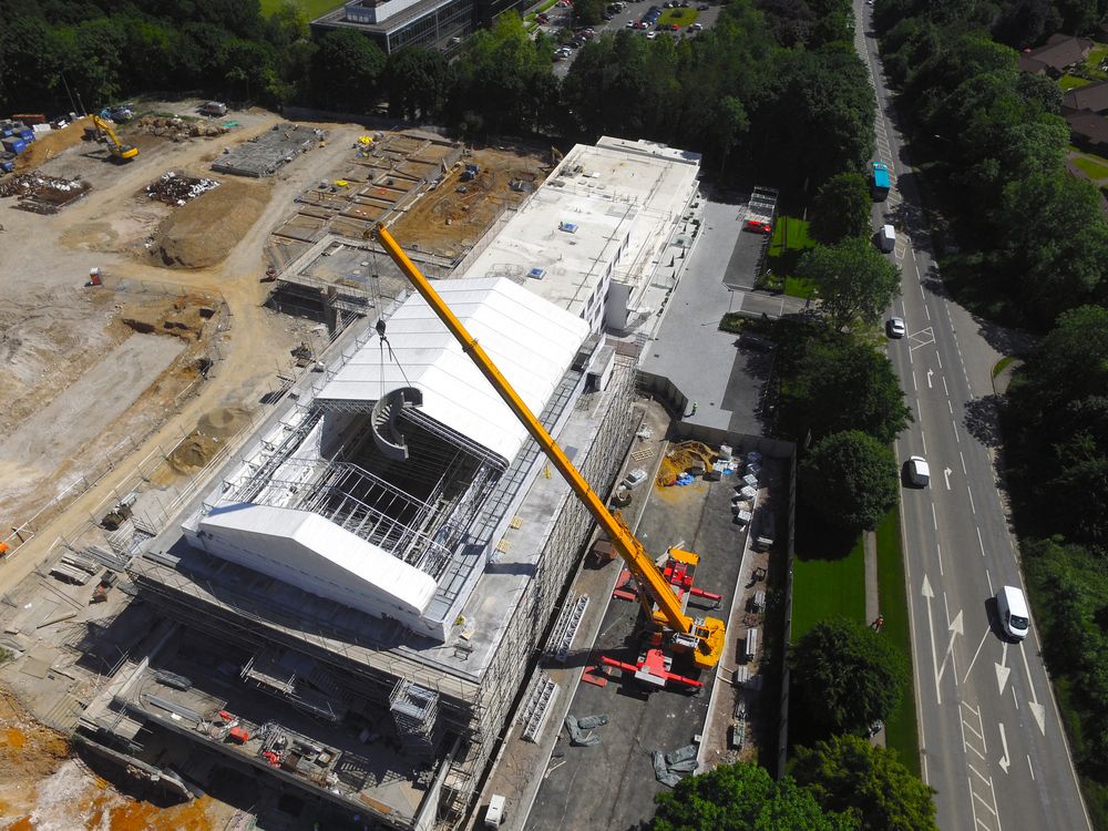 aerial view of mobile crane lift installation of precast concrete curved helical staircase in Denham, Bucks