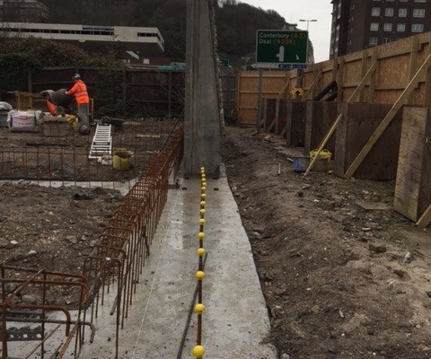 Installation of flint embossed precast concrete retaining wall in Dover, UK