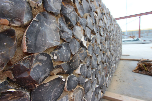 Close up of flint embossed precast concrete retaining wall installed in Dover, UK