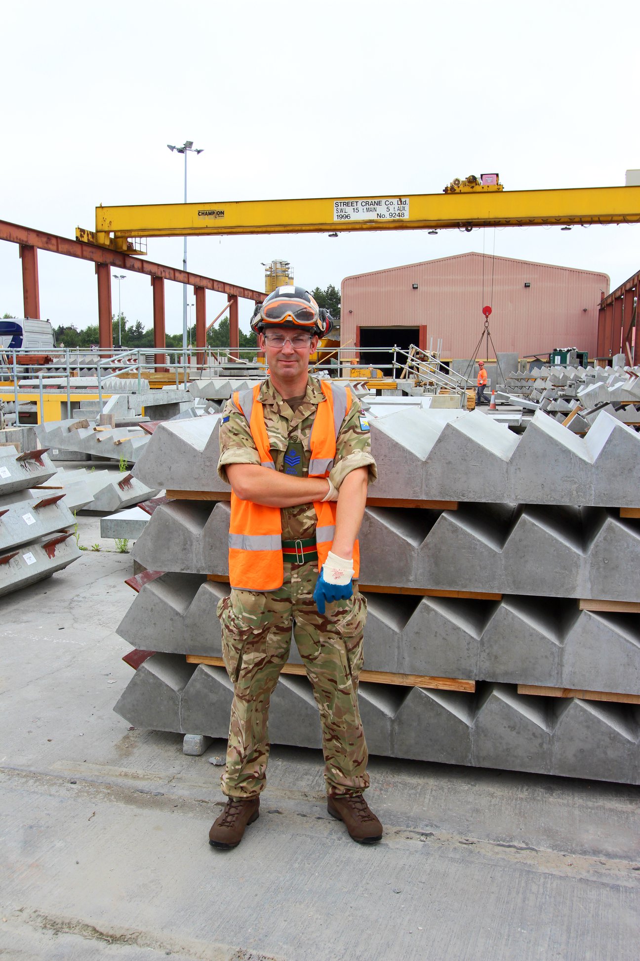 Army reservist Milbank employee poses in front of precast concrete stairs on armed forces day