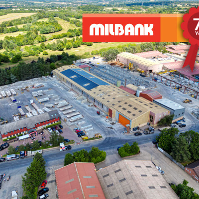 Aerial view of milbank concrete products factory with logo and 75th year anniversary rosette