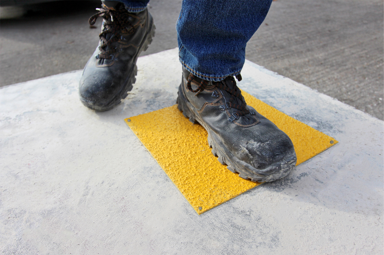 Boot steps on Safe Tread GRP anti-slip hollowcore service hole cover