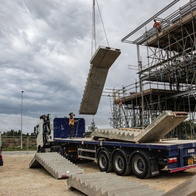 precast concrete stair is suspended by mobile crane during installation on site