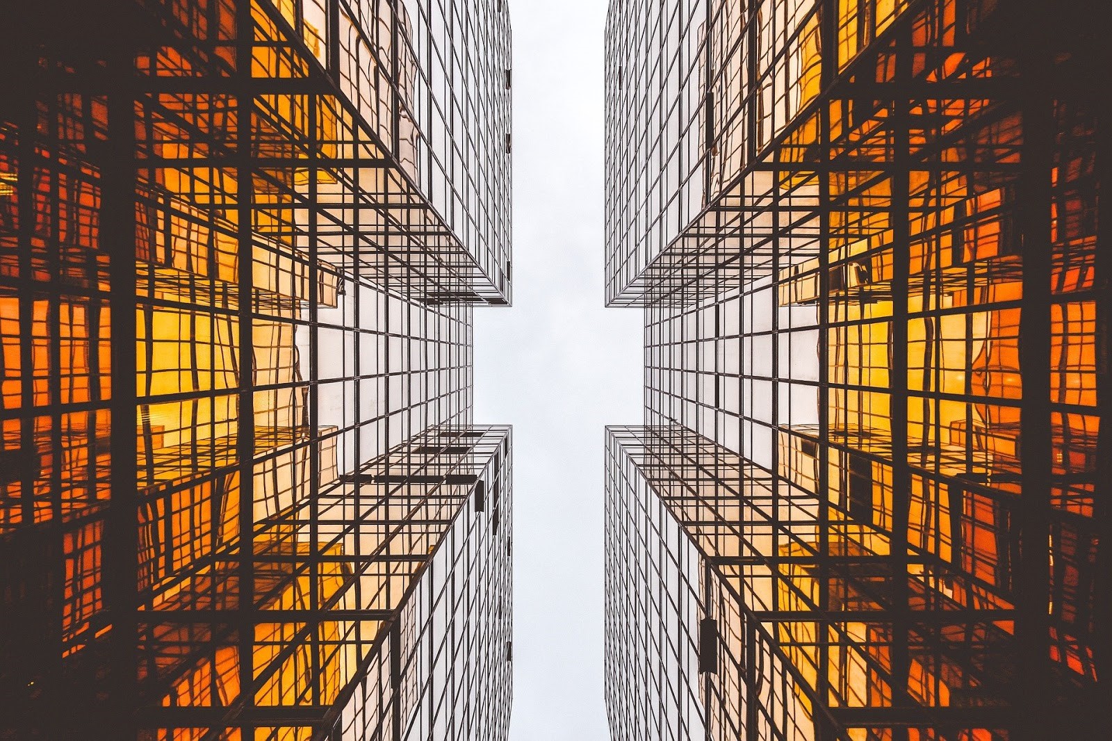 ground view looking up in between sky scraper buildings