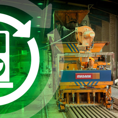 precast concrete beam machine works in factory with operatives. A green fuel logo overlays.