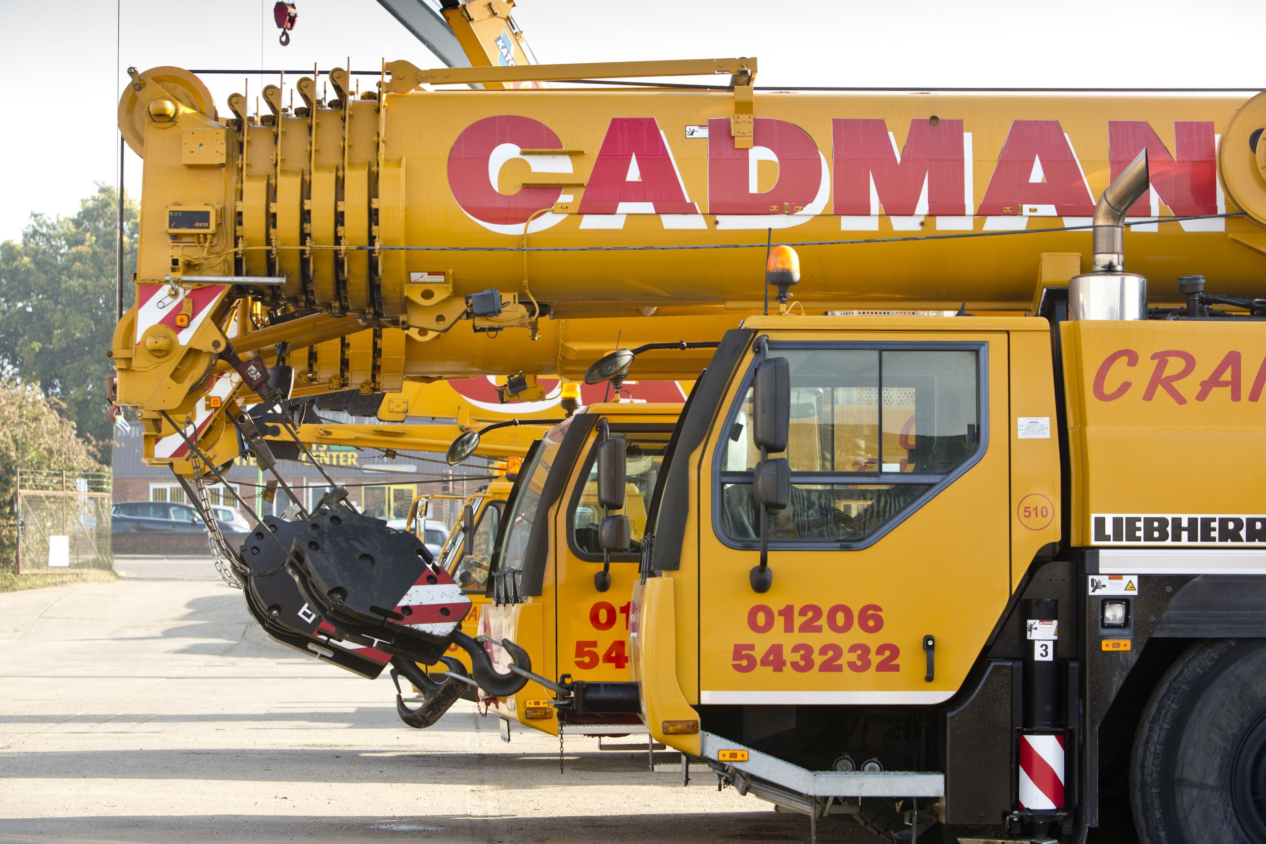 Close up of Cadman Cranes machines parked in a row