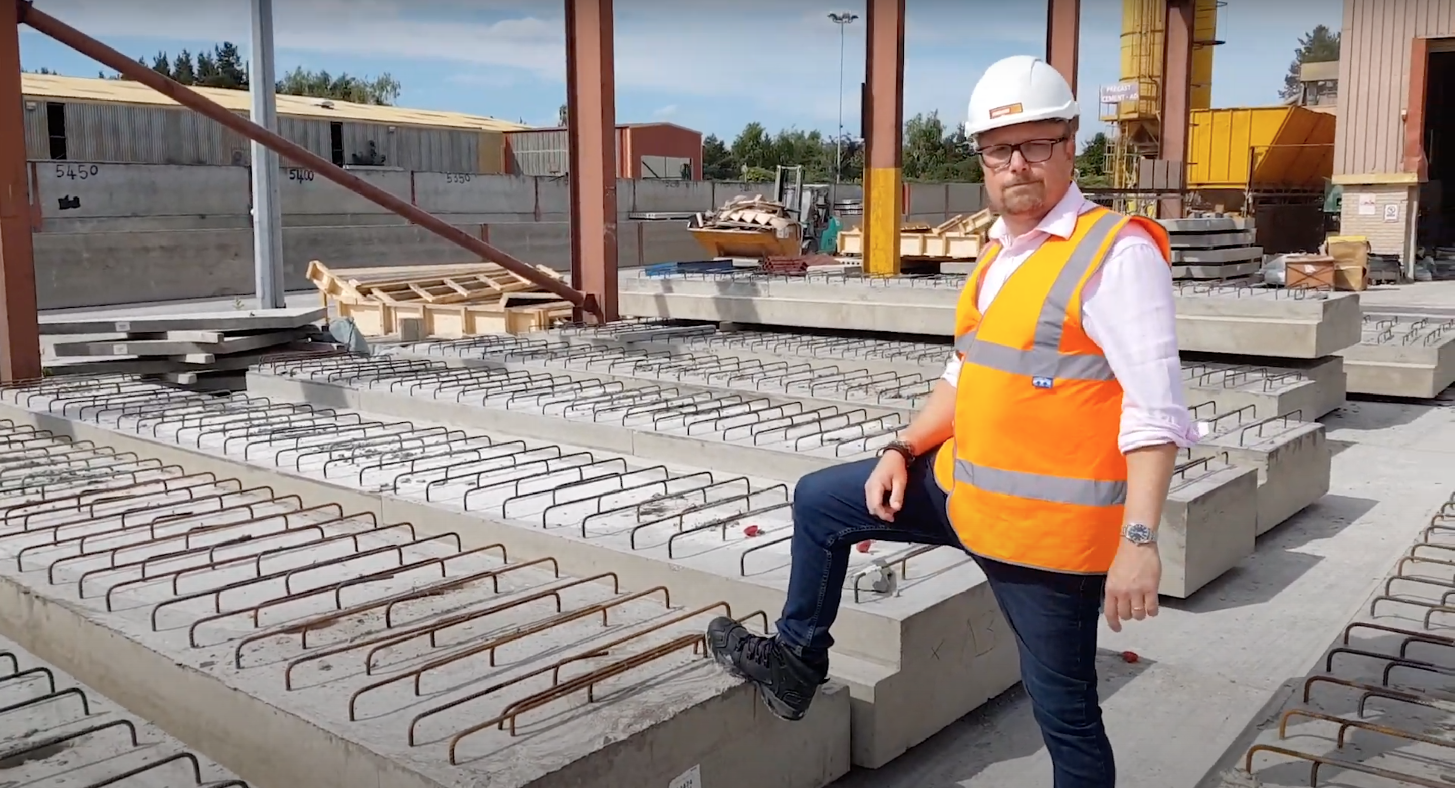 Mark Ellis poses with specialist precast concrete ground beams in production yard