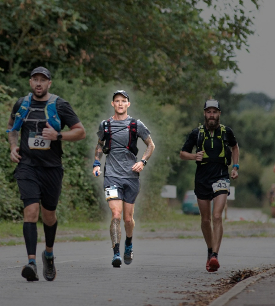 3 men run down a road, the middle man is highlighted