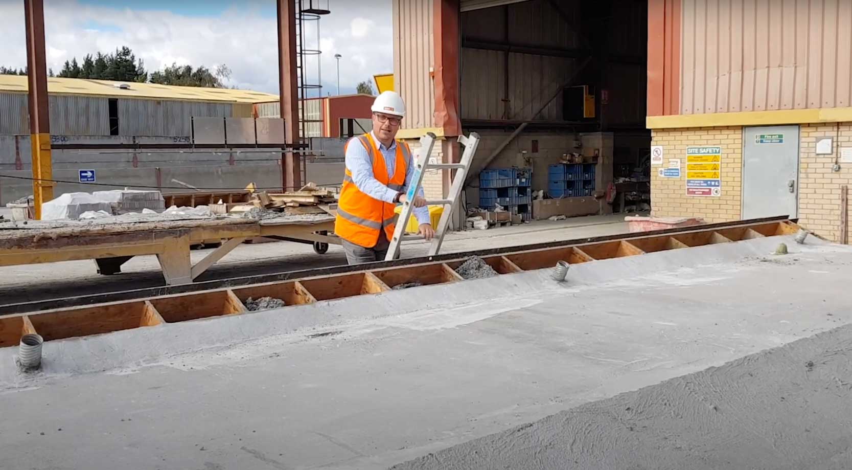 Mark Ellis climbs ladder in production yard