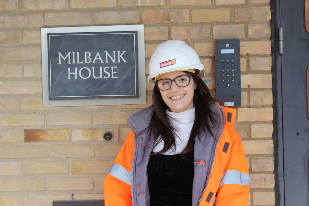 Vikki Lawson poses in front of Milbank House sign for women at milbank feature