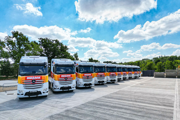 Ten Milbank ridged lorries lined up in yard