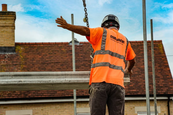 Milbank employee uses hand signals in installation of Hollowcore beam