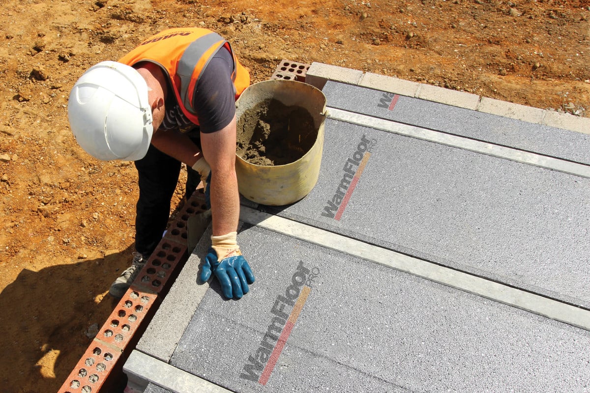 Milbank employee installing Warm Floor Pro alternative flooring