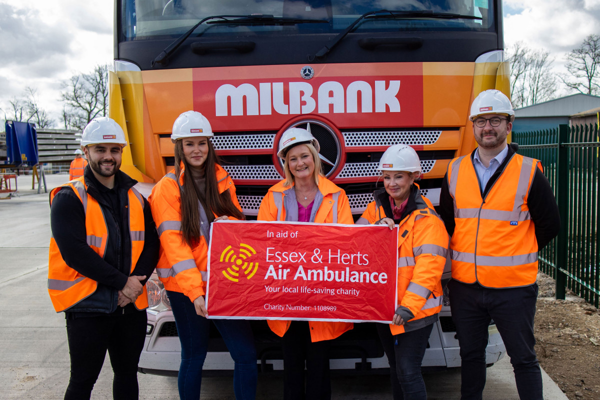 Milbank team holding Essex & Herts Air Ambulance banner