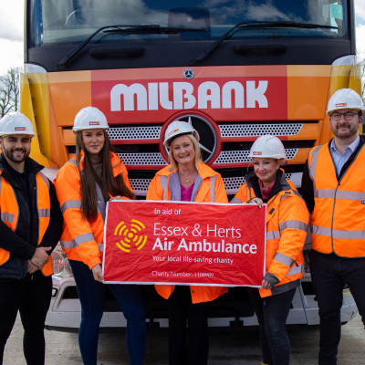 Milbank team holding Essex & Herts Air Ambulance banner