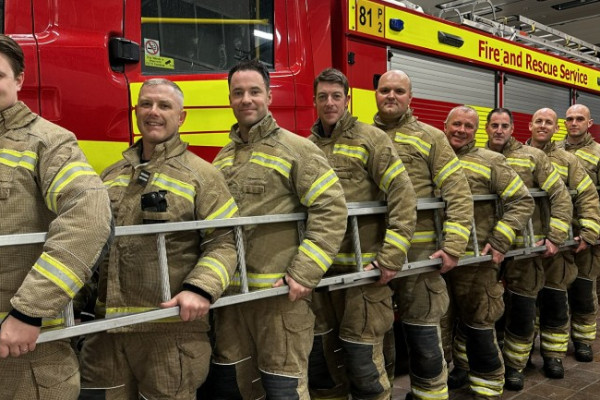 Halstead Fire Station crew hold ladder in front of fire engine